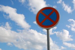 No Parking Traffic Road Sign. The Urban Clearway Sign With Blue Sky Cloudy Background.